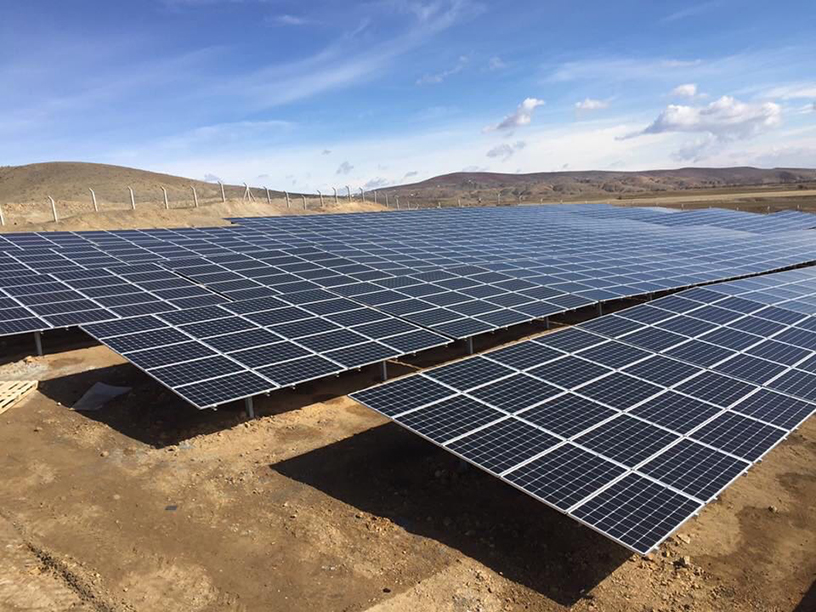 Photovoltaic solar park in Elazığ, Turkey, featuring rows of PV modules on galvanized steel structures in a dry landscape