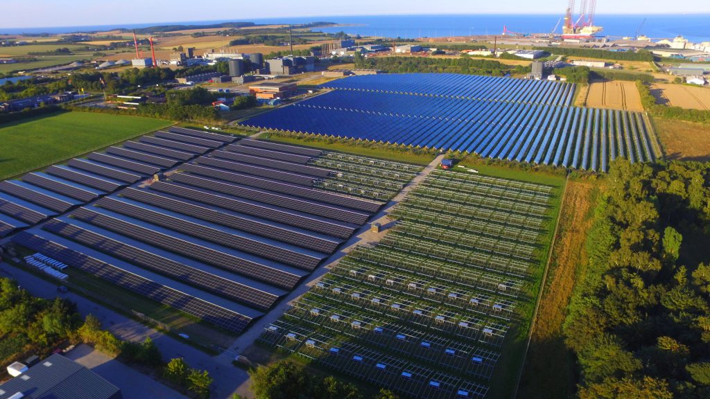 Aerial view of the Grenaa solar park in Denmark near the coast with large photovoltaic installations